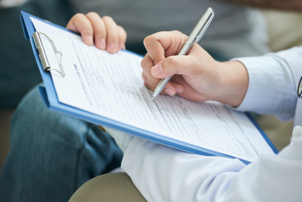 hands-unrecognizable-female-doctor-filling-form-clipboard.jpg